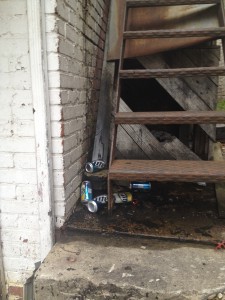Litter under the stairs at The White Tiger's former locale. There are many signs of neglect all around the property. Photo by María Helena Carey