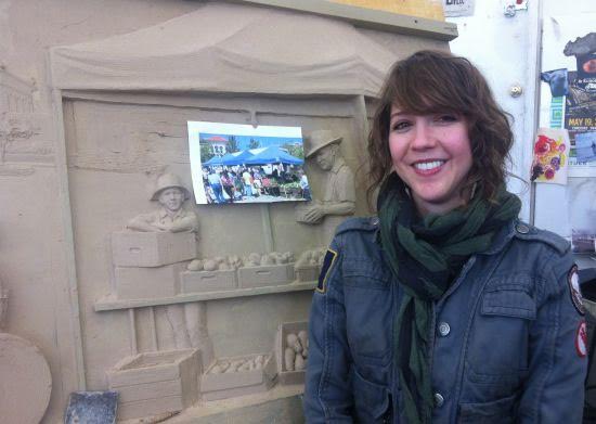Joanna Campbell Blake poses in front of the mold for a frieze destined for Opelika, AL. Photo courtesy of Margaret Boozer. 