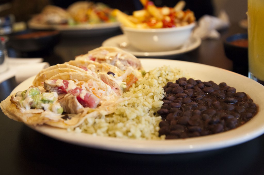 The aforementioned fish tacos, served with cilantro rice and black beans. Photo by María Helena Carey