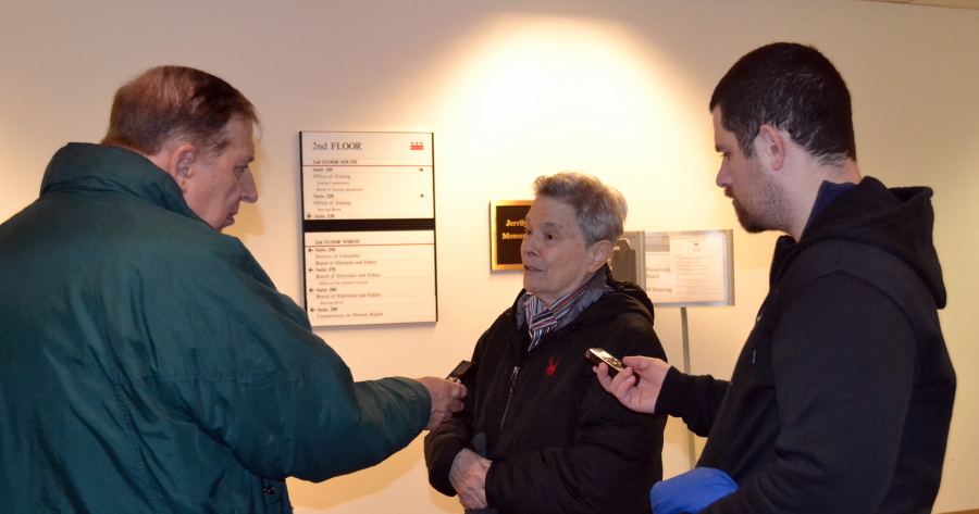 Joan Biren being interviewed by the press (Left: Lou Chibbaro Jr.of the Washington Blade, Right: John Riley of the Metro Weekly)