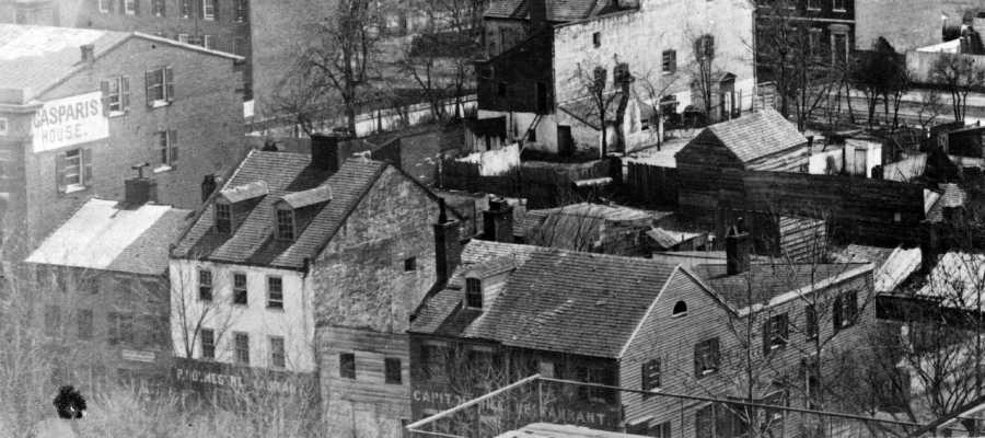 In this detail of an 1863 picture, taken from the top of the Capitol, Casparis's old and new buildingd can be seen: The old bowling alley is front and center, marked “Capitol Hill Restaurant” while the new hotel is all the way to the left. (LOC)