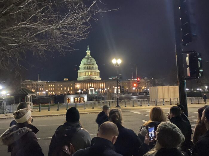 the united states capitol in the background. in the foreground, a tour group led by The Hill is Home's Robert Poh